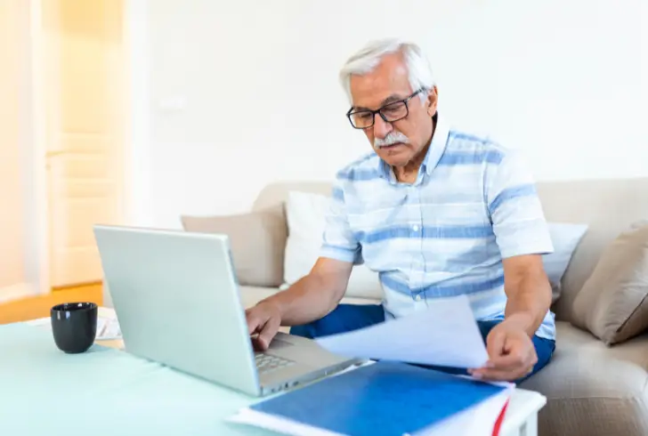 Senior reading Medicare plan