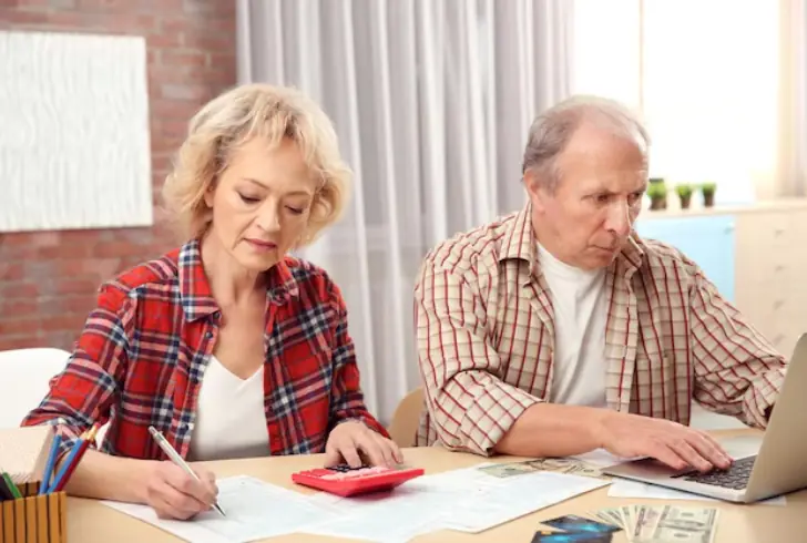 Senior reviewing money and documents