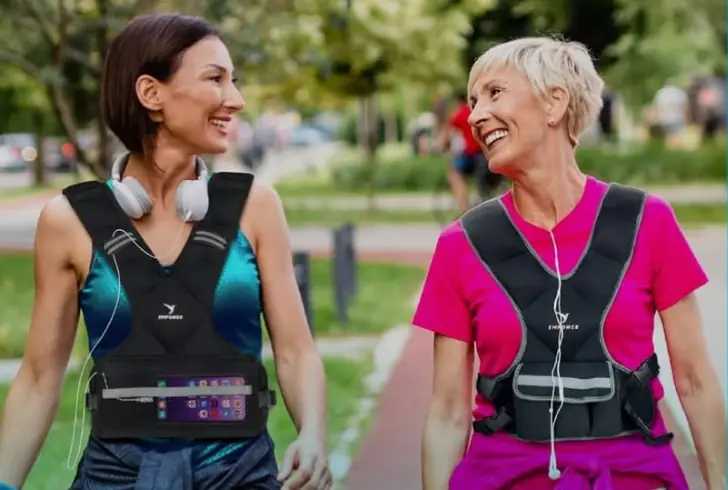 Two womens walking with light weighted vest