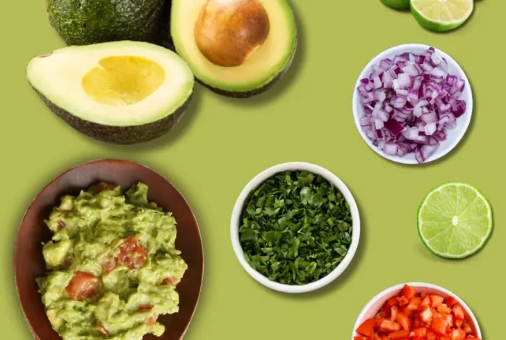 Delicious Spicy Guacamole recipe with avocado, tomatoes, jalapeño, lime, and cilantro.